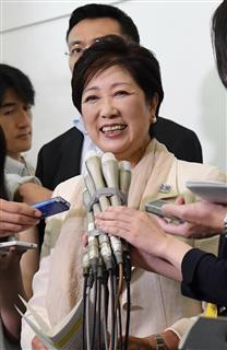 リオ五輪の閉会式へ向けて出発する前に報道陣の質問に答える、小池百合子東京都知事（中央）＝１８日午前、東京都大田区の羽田空港（寺河内美奈撮影）
