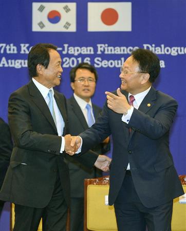 日韓財務対話を終え、笑顔で言葉を交わす麻生財務相（左）と韓国の柳一鎬・経済副首相兼企画財政相＝２７日、ソウル（共同）