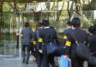 家宅捜索のため電通中部支社に入る愛知労働局の職員ら＝７日午前９時３３分、名古屋市