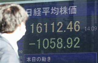 米大統領選の開票でトランプ氏の優勢が伝えられる中、一時１０００円以上値を下げた日経平均株価を示すボード＝９日午後、東京・八重洲