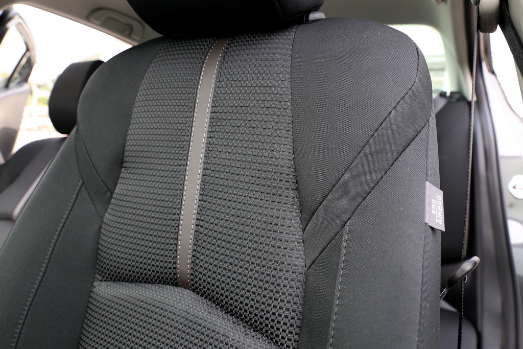 ステッチ入りのファブリック素材のシート。体を包み込むような形状でホールド性が高い。座り心地は硬め