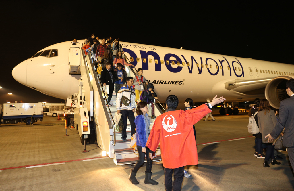 観賞フライトを終えて成田空港に帰着、チャーター機から降りてくる参加者