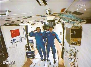 ２０１６年１０月、北京の宇宙飛行管制センターのモニターに映し出された「天宮２号」の宇宙飛行士（新華社＝共同）