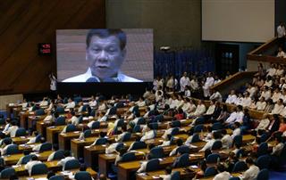 議会で演説するフィリピンのドゥテルテ大統領（中央画面）＝７月、首都マニラ（ＡＰ）
