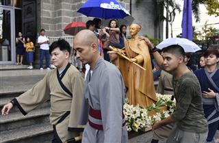 フィリピンの首都マニラで、関係者らに運ばれる高山右近の像＝２０１８年１２月（共同）