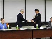 中央最低賃金審議会に対し、令和元年度の最低賃金の引き上げ額の目安について諮問を行った根本匠厚生労働相（右）＝７月４日、厚生労働省