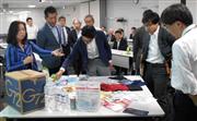 災害支援物資「Ｇ７２ＢＯＸ」の中身を確認する防災担当者ら＝東京都内