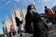 イタリアのミラノで新型コロナウイルスの感染を防ぐためにマスクを着用している女性（ロイター）