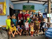 物資の配布後、住民らと記念撮影する石田兼一氏　（中央緑色のシャツ、同氏提供）