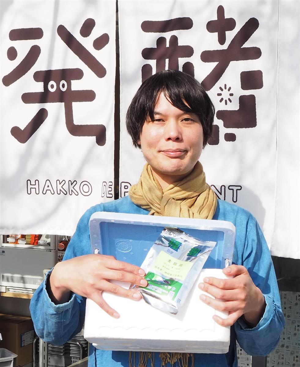 種麹と発泡スチロールのミニ麹室。家庭用麹づくりキットを手にする小倉ヒラクさん＝東京都世田谷区の「発酵デパートメント」（重松明子撮影）