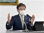 記者会見する大阪堂島商品取引所の中塚一宏社長＝６日午後、東京都中央区