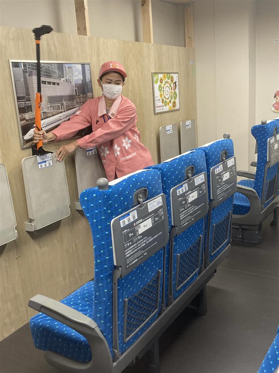 棒状の装置の上部にあるサーモグラフィーカメラで３座席のぬれの有無を同時にチェックする作業員＝２６日、ＪＲ東京駅構内